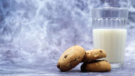 American gluten free chocolate chip cookies with glass glass of vegetable milk on gray background....