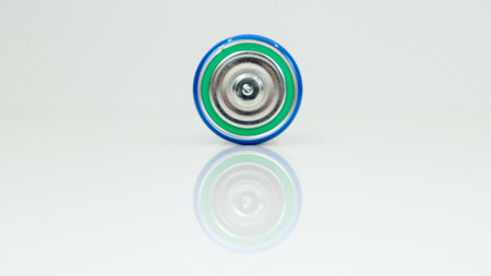 Large battery type D or C cell on white background with reflection. View of a metallic alkaline battery with copy space. Mandatory processing.の写真素材