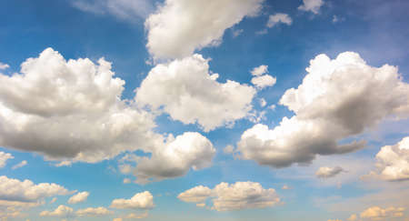 Blue sky with white plump fluffy clouds and sun. Cumulus clouds. Nature weather blue sky. Beautiful background white clouds.の写真素材
