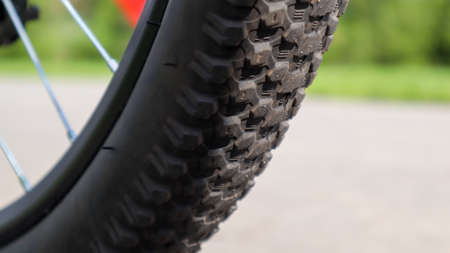 Mountain bike wheel and mud tire close.