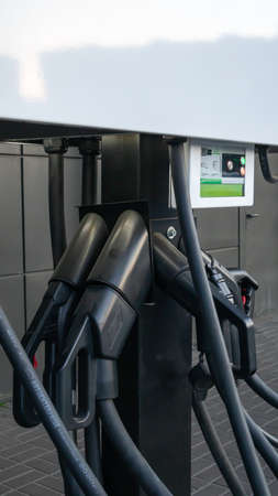 Public charging station for electric vehicles in the parking lot. Charger for public electric...