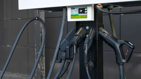 Public charging station for electric vehicles in the parking lot. Charger for public electric...
