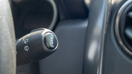 Handle for wipers control. Right wiper motor control switch. Detail of the car interior and adjustment of the speed of the wipers. Car windshield cleaner from rain. Remove dirt from the windshieldの写真素材