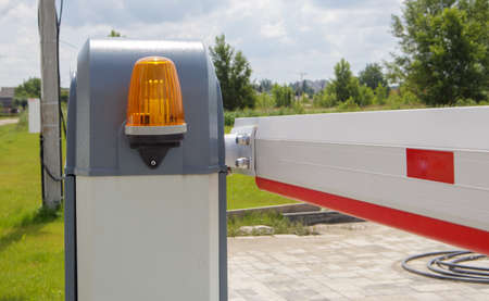 Close the gate. Automatic security system. Automatic entry system. Yellow light signal with a street...