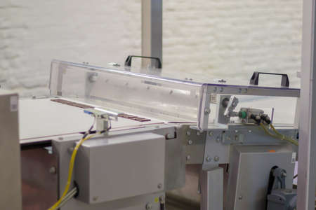 Line for the production of chocolate in an industrial factory. Automatic process in the production line of sweets. Images from the chocolate factory during production. Conveyor belt with sweetsの写真素材