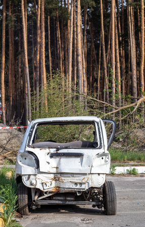 Broken minicar after a traffic accident in the parking lot of a repair station. Car body damage workshop outdoors. Sale of insurance cars at auction. Damage to the car body after the accidentの写真素材