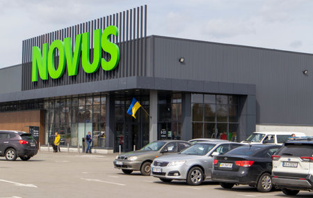 Ukrainian supermarket chain Novus. Green large signboard of the shopping center outside, on the...