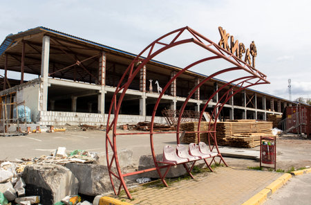 Devastating landscapes with a burnt and broken facade of a shopping center. Translation Giraffe. The terrible consequences of the war in Ukraine. Ukraine, Irpin - April 29, 2023のeditorial素材