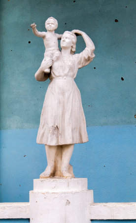 A statue of a mother and child that was damaged by shelling. A statue battered by rocket fragments stands at the bombed-out cultural center. Ukraine, Irpin - May 06, 2023のeditorial素材