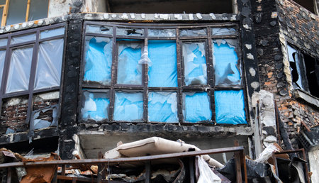 Window of the house with broken glass. selective focus. The windows in the apartment building were damaged by the blast and shell fragments. Destruction, the consequencesの写真素材