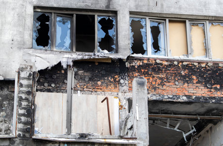 Residential, windows and balconies were damaged by the blast and shrapnel from artillery buildings shelling. The destruction of the city by military operations, the consequencesの写真素材