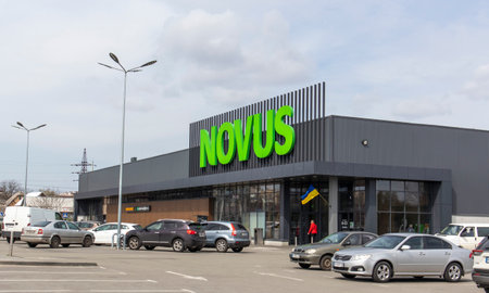 Ukrainian supermarket chain Novus. Green large signboard of the shopping center outside, on the street. Signboard against the sky. The building of the supermarket. Ukraine, Kyiv - May 01, 2023.のeditorial素材