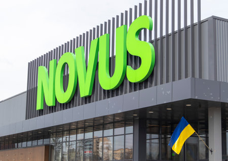 Ukrainian supermarket chain Novus. Green large signboard of the shopping center outside, on the street. Signboard against the sky. The building of the supermarket. Ukraine, Kyiv - May 01, 2023.のeditorial素材