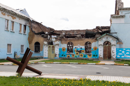 The ruins of a destroyed house of culture after the occupation in the Kyiv region. War of Russia against Ukraine. Facade of a bombed-out historic architecture building. Ukraine, Irpin - May 06, 2023.のeditorial素材