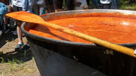 Tomato soup with pasta is a Polish dish. Zupa pomidorowa. Hot soup made from grated tomatoes. People and tourists walk, eat and buy food at the street food festival. Ukraine, Kyiv - August 17, 2023.のeditorial素材