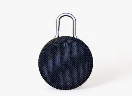Waterproof round black speaker with carabiner. Digital music and sound concept. Mini, suitable for...