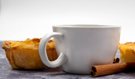 Lots of desserts Pastel de nata or Portuguese egg tart and cinnamon sticks with a cup of coffee....