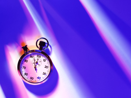 An overhead view of a sports stopwatch on a blue background with copy spaceの写真素材