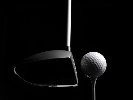 Golf wood with a golf ball and golf tee Isolated on blackの写真素材