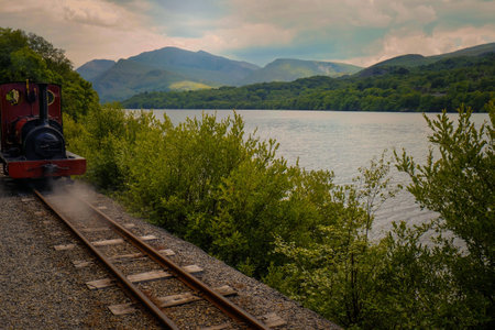 Train on the tracks at the lakeside railwayの写真素材