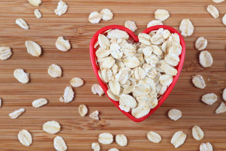 Oatmeal in a heart bowl. Close-up.の写真素材