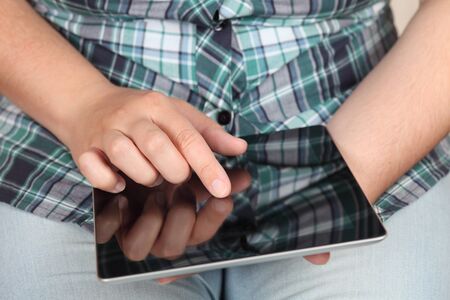 Woman touching the screen of a tablet computer. Close-up.の写真素材