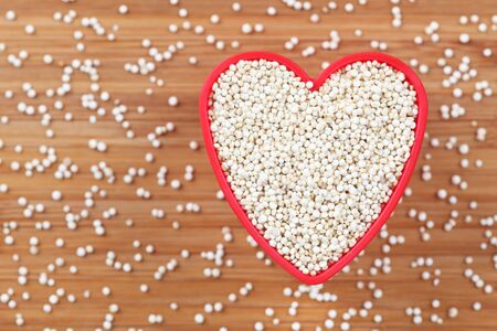 Quinoa in a heart bowl. Close-up.の写真素材