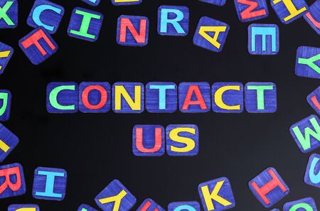 Words \"Contact us\" spell out on black and letters. Letters drawn by me.の写真素材
