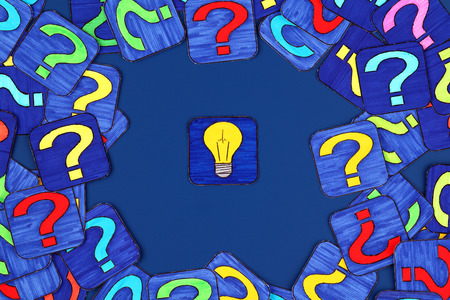 Yellow light bulb and a lot of question marks on blue . Pictures drawn by me.の写真素材
