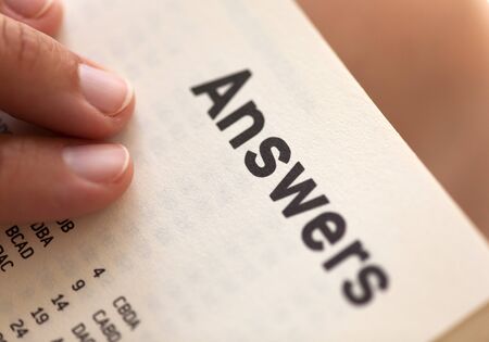 Woman's hands on book page with title