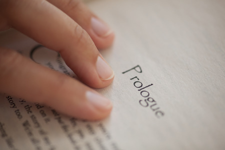 Woman's hand on book page with titleの写真素材
