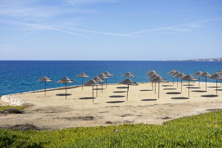 Sky, sea and sandy beach with umbrellas. Mediterranean Sea. Cyprus.の写真素材