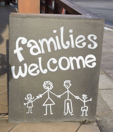 Â«Families welcomeÂ» sign in the street.の写真素材