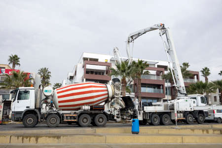 Paphos, Cyprus - December 20, 2013 Ð¡onstruction's cars working on the construction of a new hotel near KFC restaurant on Paphos street. Urban scene.のeditorial素材