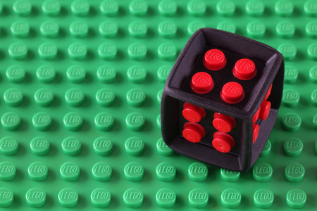 Tambov, Russian Federation - May 08, 2013  LEGO Cube on a green baseplate. Studio shot. LEGO is a popular line of construction toys manufactured by the Lego Group (Billund, Denmark).のeditorial素材