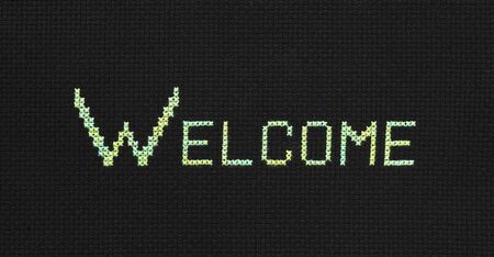 The embroidered word "Welcome" on black canvasの写真素材