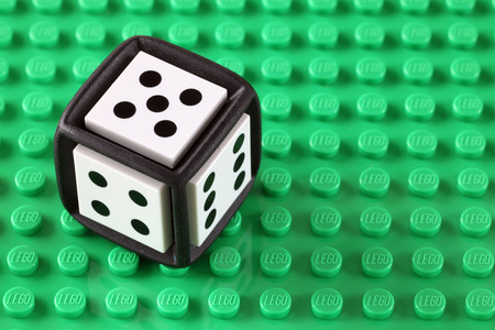 Tambov, Russian Federation - May 08, 2013  LEGO Cube on a green baseplate. Studio shot. LEGO is a popular line of construction toys manufactured by the Lego Group (Billund, Denmark).のeditorial素材