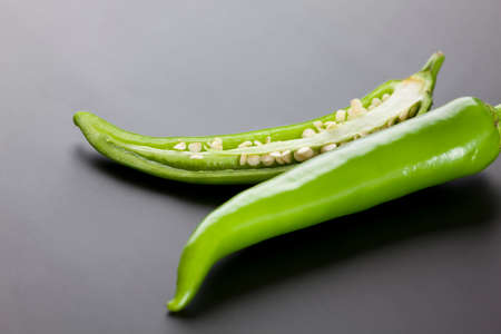 Green chili peppers on black backgroundの写真素材