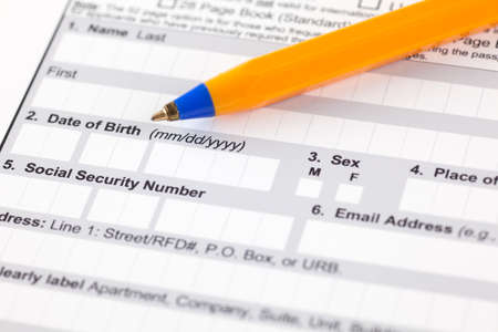 Application form with ballpoint pen. Focus on date of birth and social security number.