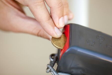 Woman's hand putting 50 euro cent into lockの写真素材
