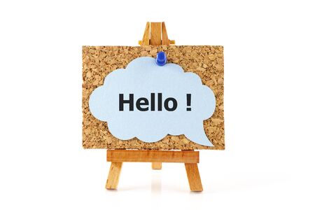 Wooden easel with corkboard and blue speech bubble with word Hello! isolated on white backgroundの写真素材