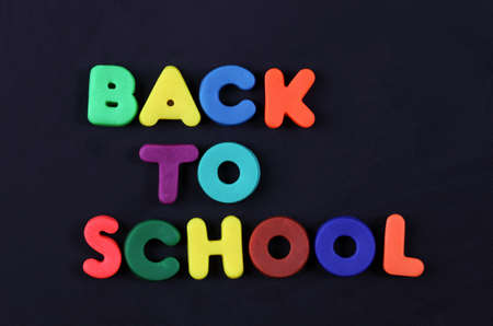 "Back to school" of child's play clay on a black background.の写真素材