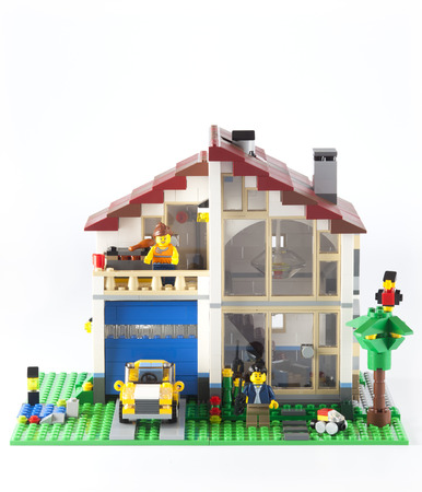 Tambov, Russian Federation - January 08, 2014 LEGO Family House with yellow car and couple minifigures on white background. のeditorial素材