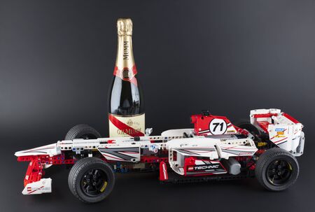 Tambov, Russian Federation - January 12, 2014: LEGO Technic Grand Prix Racer model with bottle of Champagne G.H.Mumm Brut Cordon Rouge on black background. Item 42000. It model motorized with 8293 LEGO Power Functions Motor Set. Studio shot. G.H. Mumm is のeditorial素材