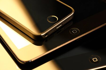 Tambov, Russian Federation - February 26, 2015 Close up of stack of Apple devices -  iPhone 5s, iPad mini and iPad 2. Studio shot.のeditorial素材