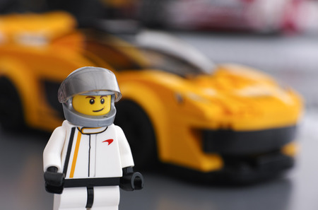 Tambov, Russian Federation - March 09, 2015 Lego McLaren P1 driver minifigure by LEGO Speed Champions and his car on background. Focus on the driver uniform. Studio shot.のeditorial素材