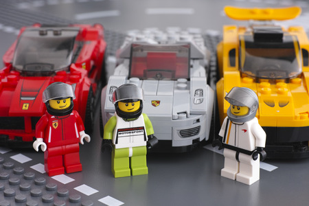Tambov, Russian Federation - March 14, 2015 Lego drivers minifigures by LEGO Speed Champions and his car on background. There are Lego LaFerrari, Lego Porsche 918 Spyder and    Lego McLaren P1 cars. Studio shot.のeditorial素材