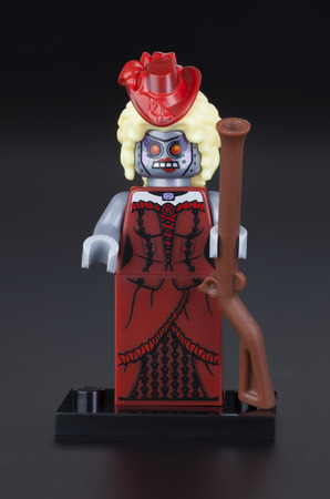 Tambov, Russian Federation - February 10, 2014 LEGO Calamity Drone minifigure with rifle on black background. LEGO Movie series. Studio shot. LEGO is a popular line of construction toys manufactured by the Lego Group (Billund, Denmark).のeditorial素材