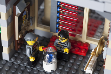 Tambov, Russian Federation - August 26, 2014 LEGO night museum break-in. Two robbers minifigures in museum with diamond. Studio shot. LEGO is a popular line of construction toys manufactured by the Lego Group (Billund, Denmark).のeditorial素材