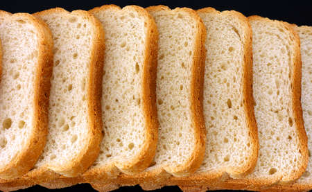 White bread slices in a row on black background